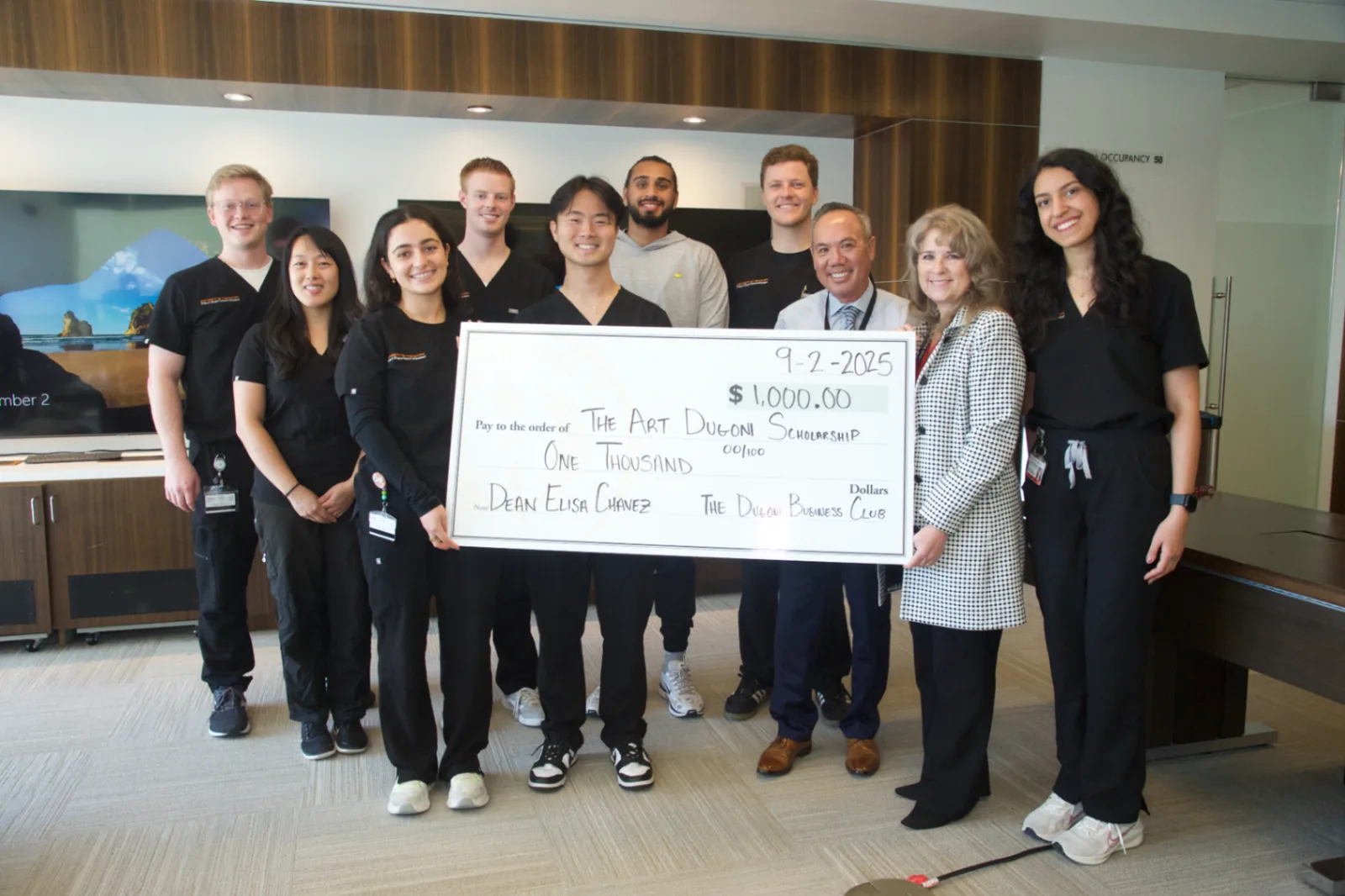 Dugoni Business Club members presenting a donation check to the Arthur A. Dugoni School of Dentistry.