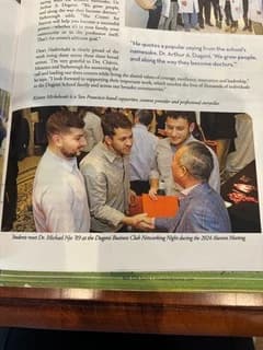 Publication spread showing Dr. Michael Njo speaking with younger dental professionals at the Dugoni Business Club networking night.