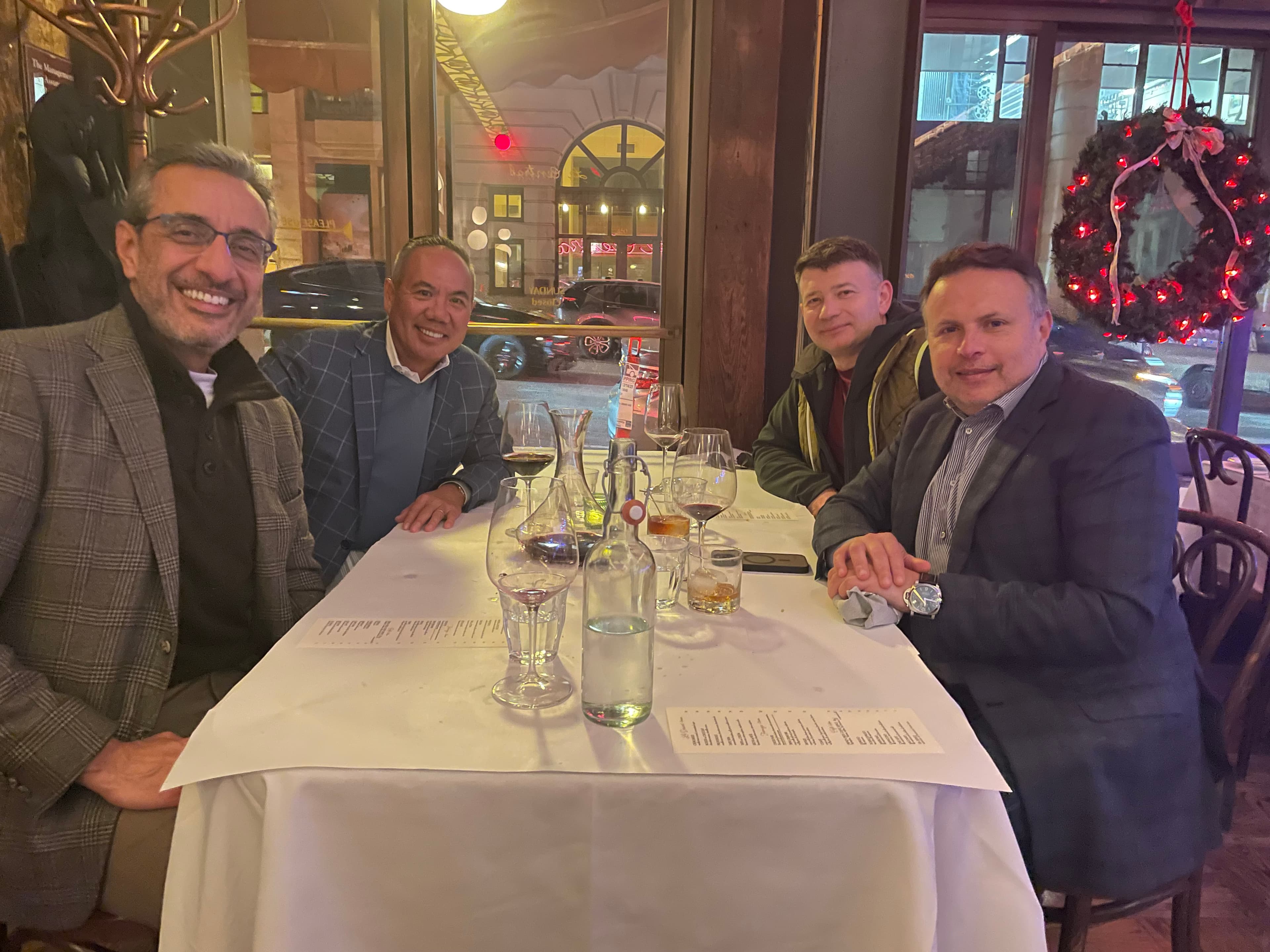 Dr. Michael Njo with peers at an evening strategy dinner.