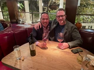Dr. Michael Njo with a colleague at an evening industry dinner.