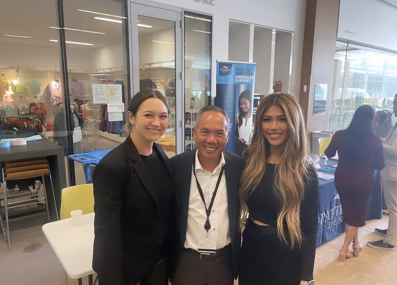 Dr. Michael Njo with two industry sponsor representatives at the Dugoni Business Club Symposium vendor fair.
